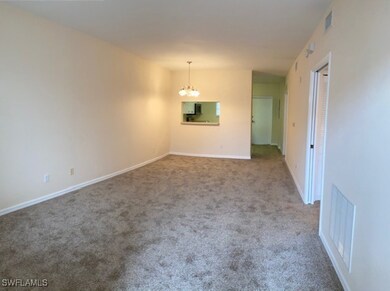 Carpeted spare room featuring baseboards, visible