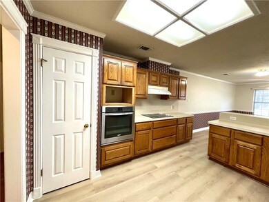 Kitchen featuring oven, black electric stovetop, u