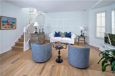 Living room featuring stairs, wood finished floors, and baseboards