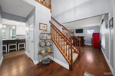 Stairway with hardwood / wood-style flooring and healthy amount of natural light