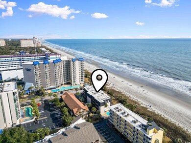 Aerial view featuring a water view and a beach vie