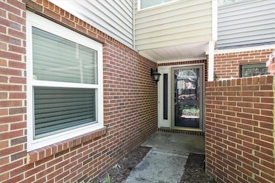 Doorway to property featuring brick siding