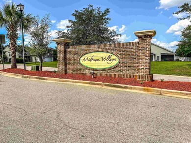 Community / neighborhood sign with a yard