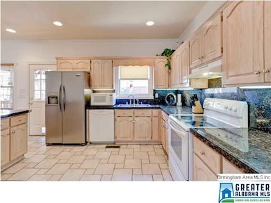 The kitchen has plenty of cabinets and counter top