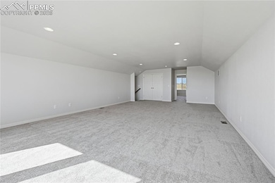 Additional living space with light colored carpet, lofted ceiling, and recessed lighting