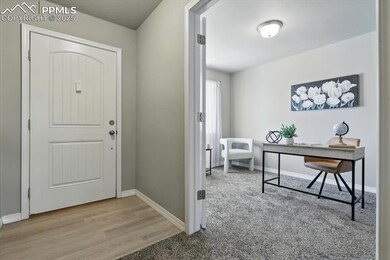Entrance foyer with baseboards and wood finished floors