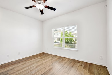 Spare room featuring light wood-type flooring and a ceiling fan