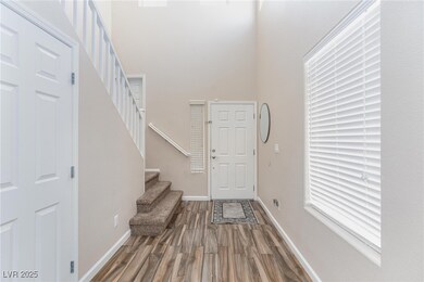 Entrance foyer featuring wood finished floors, sta