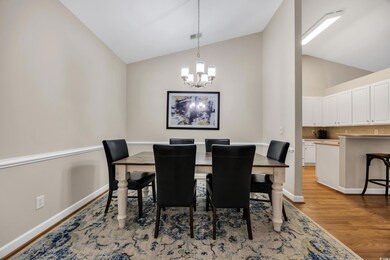 Dining room with a notable chandelier, light wood 