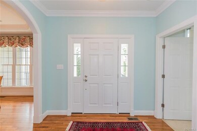 Inviting foyer with handsome moldings.  Gleaming site finished hardwood floors in all first floor living areas.