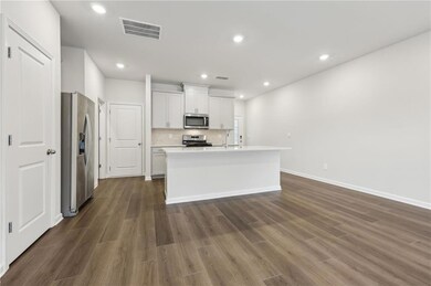 Kitchen with visible vents, dark wood-type floorin
