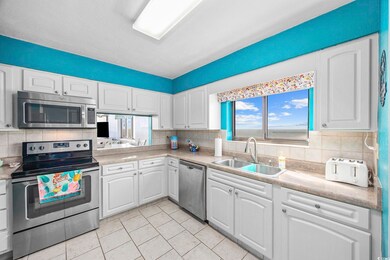 Kitchen with white cabinets, a healthy amount of s