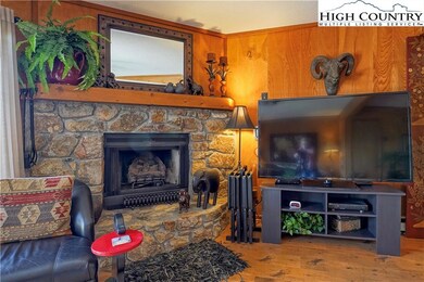 Family room w/ stone gas log fireplace
