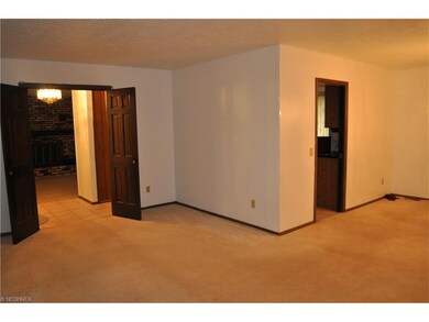 Spacious living and dining room off the front entry hall, looking towards the family room and kitchen