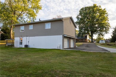 View of property exterior with central AC, a yard,