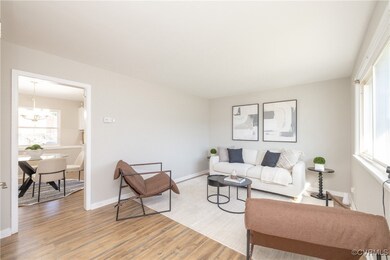 Living room featuring a notable chandelier, basebo