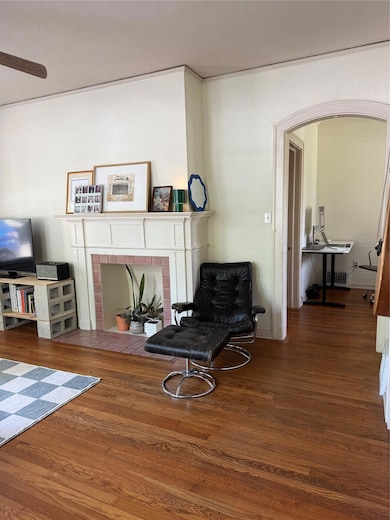 Sitting room with a brick fireplace and wood fini