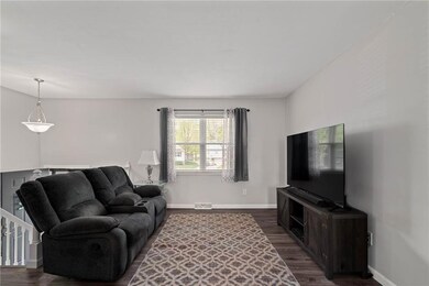 Living room with dark hardwood / wood-style floors