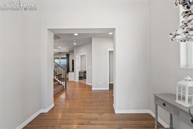 Corridor with dark hardwood / wood-style floors