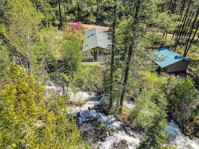 View of subject property featuring a forest