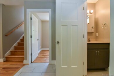 View from foyer into bonus room, half bath, and stairwell