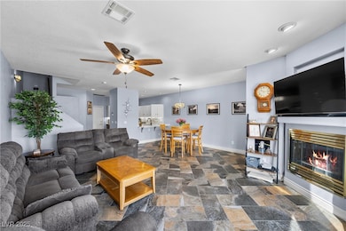 Living area featuring visible vents, stone finish