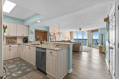 Kitchen featuring dishwasher, sink, kitchen penins