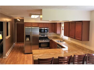 Spacious kitchen with granite counter-tops, breakf