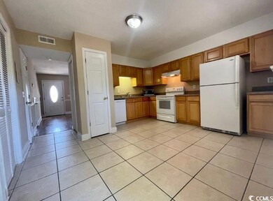 Kitchen with white appliances, under cabinet range