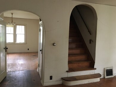 Stairway with view into dining room.