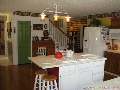 Another view of the kitchen over the cooktop islan