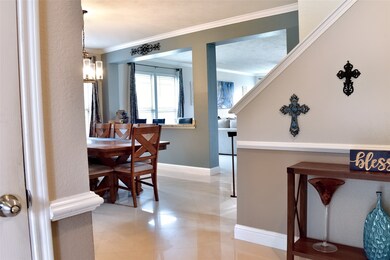 An angled view of the dining & family rooms from the foyer that showcases the floors also.