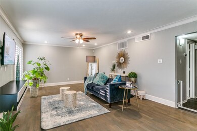 Living room with dark wood flooring, ceiling fan, 