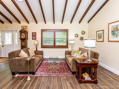 LIVING ROOM WITH EXPOSED WOOD BEAM VAULTED CEILING