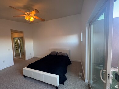 Bedroom with carpet and a ceiling fan