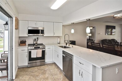 Kitchen featuring light stone countertops, a penin
