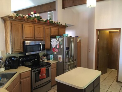KITCHEN AREA LEADING INTO UTILITY ROOM AND GARAGE