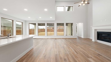 Unfurnished living room with sink, a towering ceil