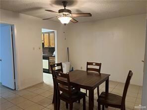Tiled dining space featuring ceiling fan