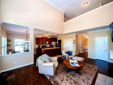 More view of great room into kitchen area. Open flooring...flows so well! Notice so much wood flooring!