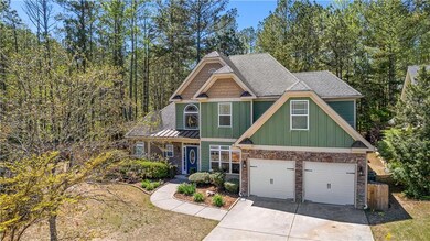 Craftsman-style house with an attached garage, sto