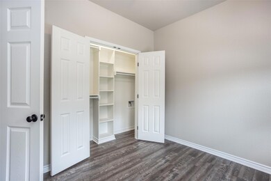 Unfurnished bedroom with dark hardwood / wood-styl