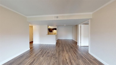 Unfurnished living room with ornamental molding, b