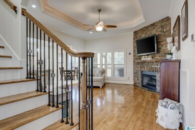 Just a little inside the foyer, you will find the staircase leading upstairs on the left. Walking straight ahead into living room that opens to fully renovated kitchen. Real hardwood floors and stacked stone fireplace, plus trey ceiling.
