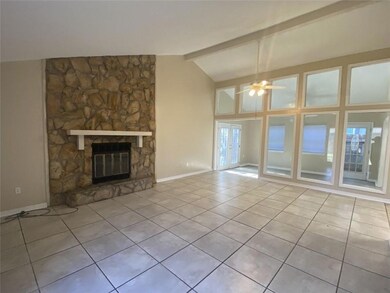 Living area with fireplace overlooking dining area