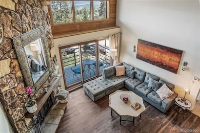 Living Room Featuring Stone Wall Fireplace
