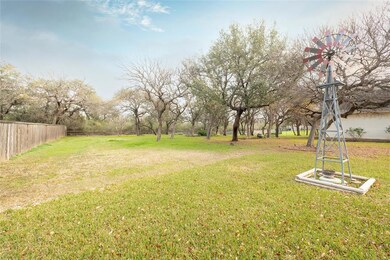 Spacious backyard with split rail fence