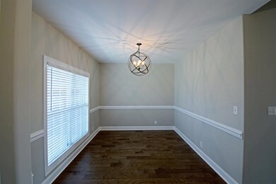 Formal Dining Room with Hardwood Flooring , Chair Rail Molding, and 10 ft Ceilings