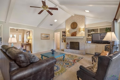 Living room with ceiling fan, lofted ceiling with 