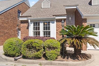 Property entrance with brick siding and a shingled